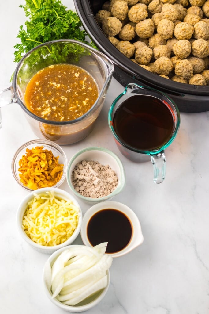 Crockpot French onion meatballs ingredients on a counter.