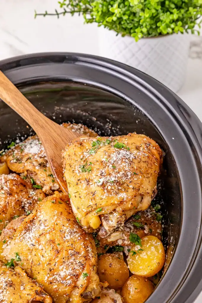 Garlic Parmesan chicken thighs and potatoes in a crockpot.