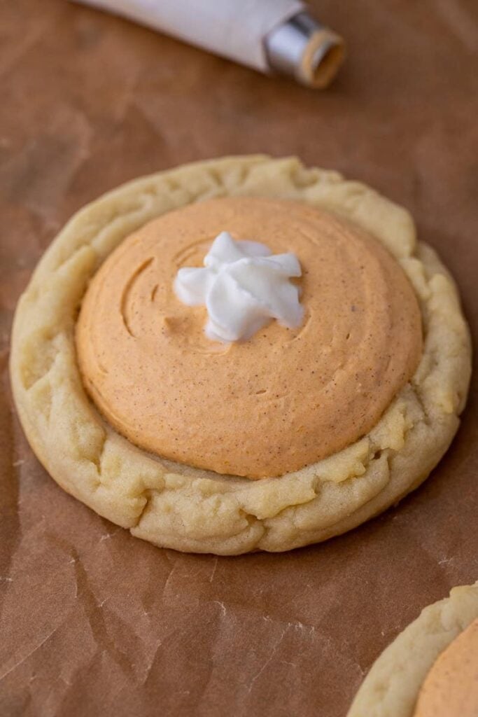 Crumbl pumpkin pie cookies on a parchment paper.