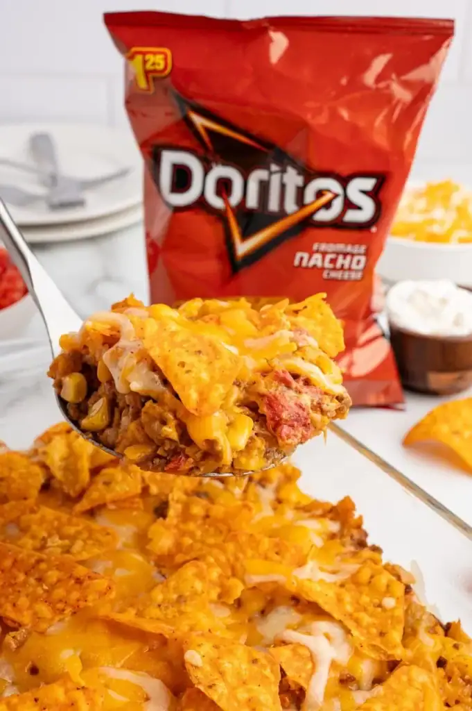 Close-up of Dorito casserole on a spoon.