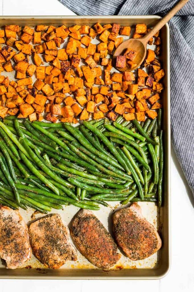Double Ranch Pork Chop Sheet Pan Dinner with green beans and sweet potatoes.