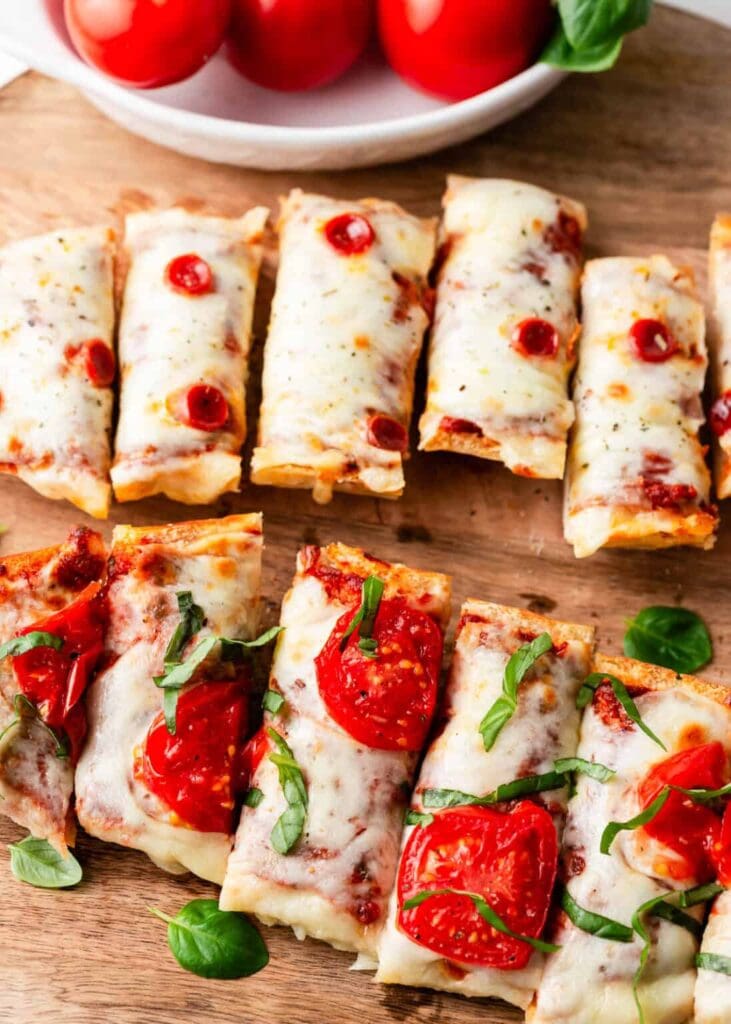 French bread pizza on a wooden board.
