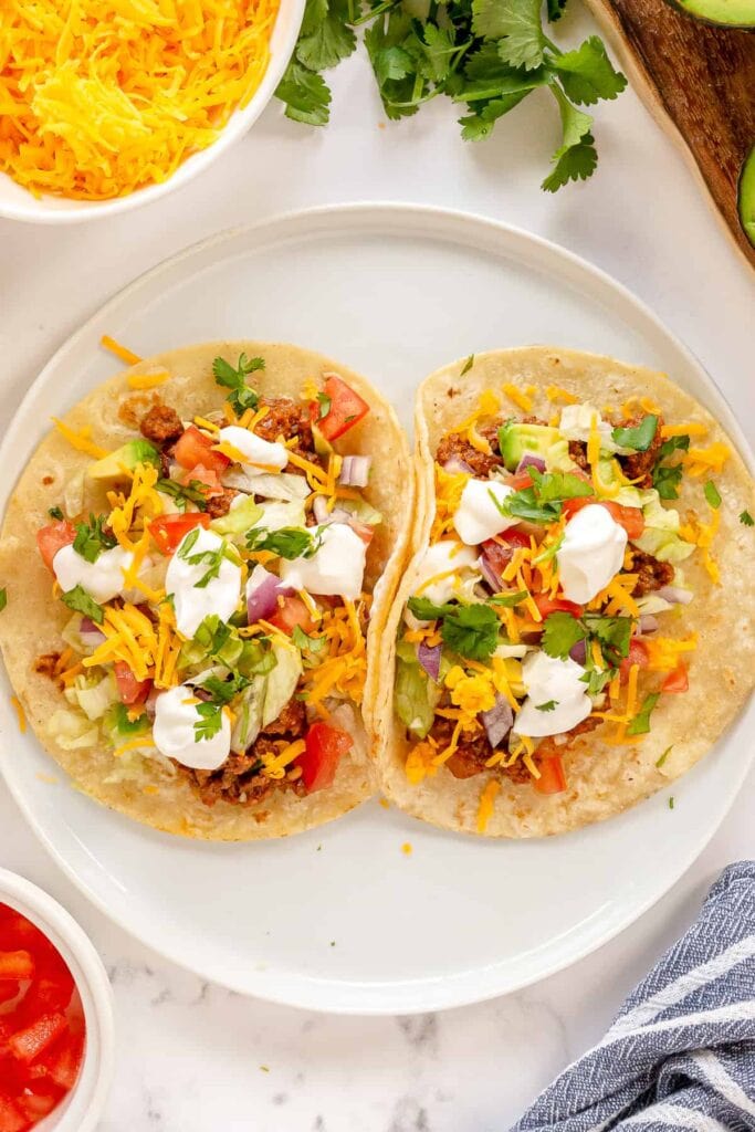 Ground beef tacos served on a plate.