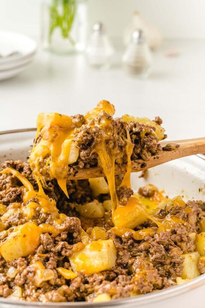 Close-up of hamburger hash on a wooden spoon.