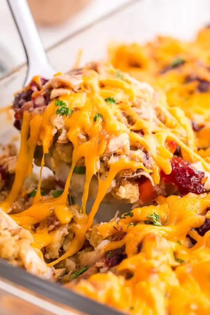 Close-up of leftover turkey casserole on a serving spoon.