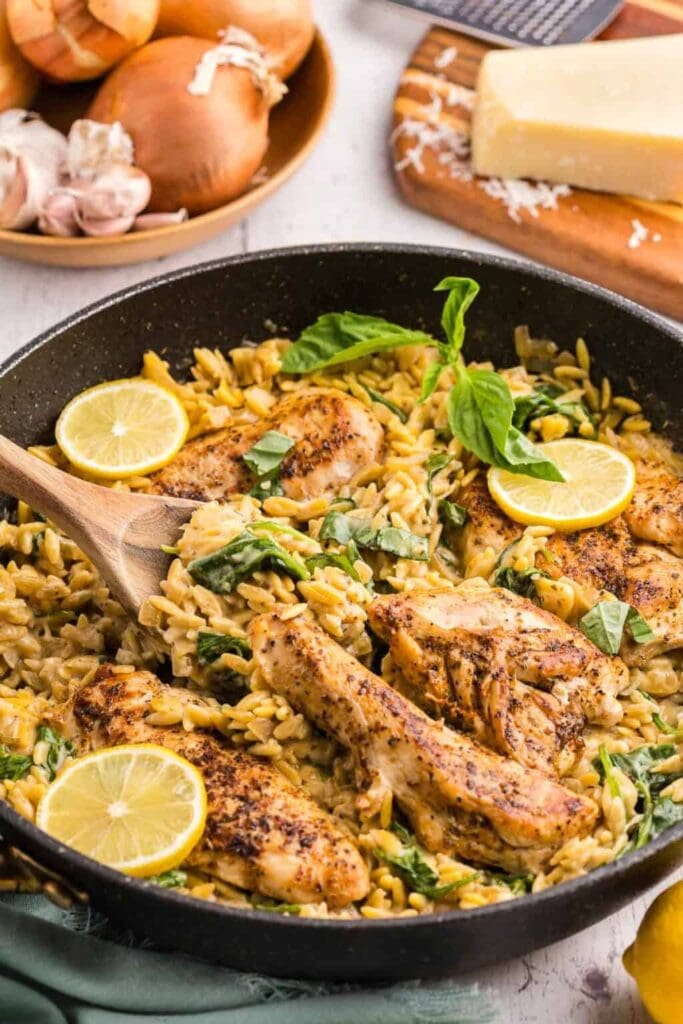 Lemon chicken orzo pasta in a skillet.