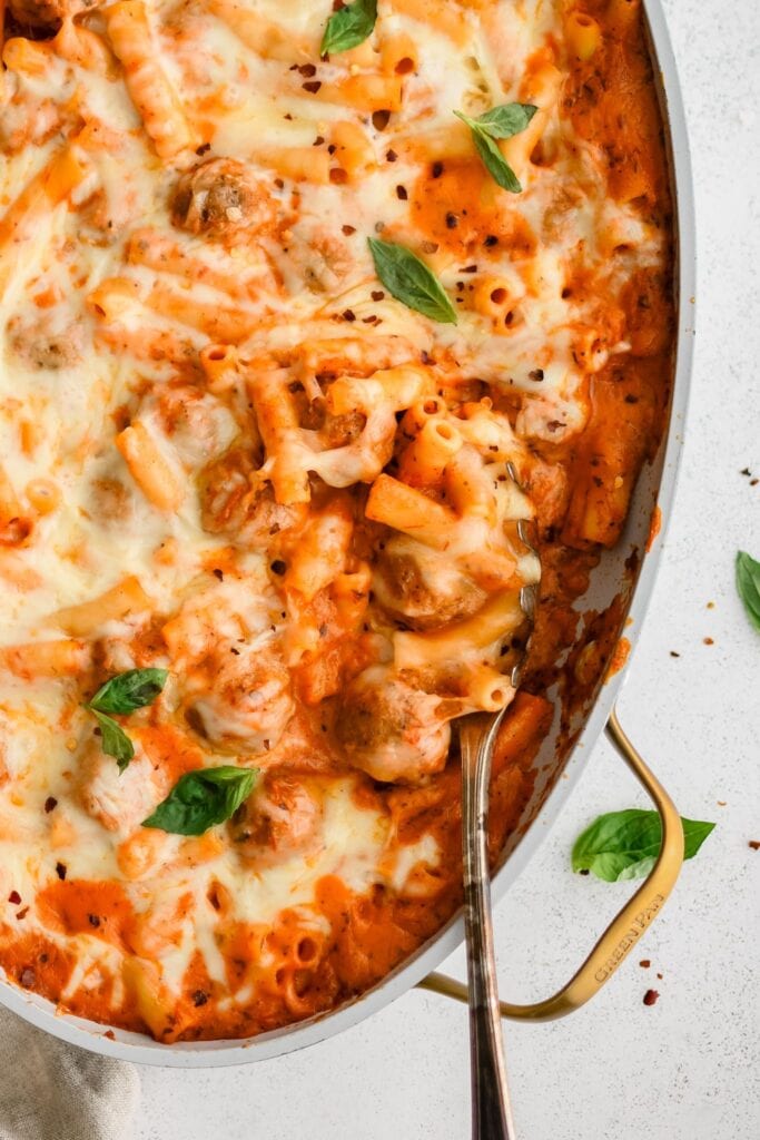 Cheesy meatball casserole in a baking pan.