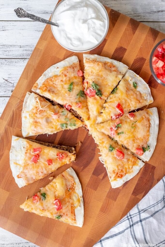 Mexican pizza on a wooden board.
