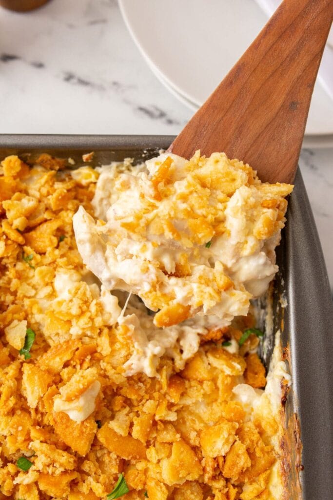 Million Dollar chicken casserole on a wooden spoon.