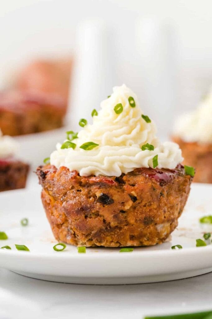 Muffin pan meatloaf served on a plate.
