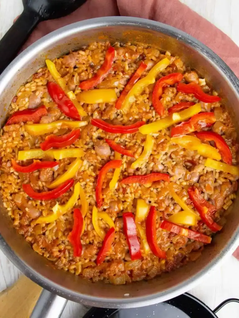 Sausage rice with peppers in a pot.