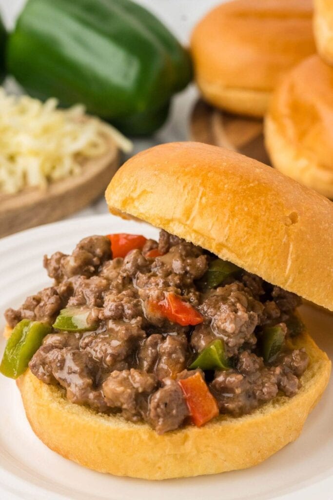 Philly cheesesteak sloppy Joes served on a plate.