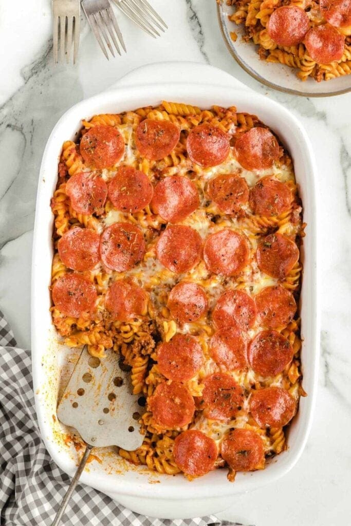 Pizza pasta casserole in a baking dish with pepperoni.