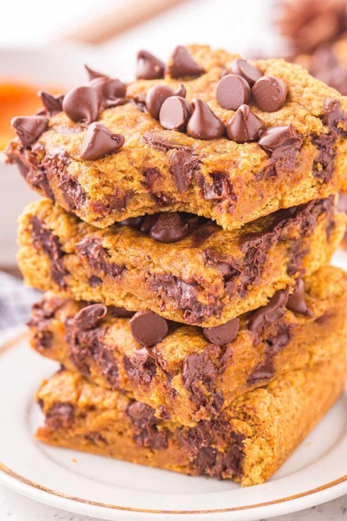 Stack of pumpkin chocolate chip bars on a plate.