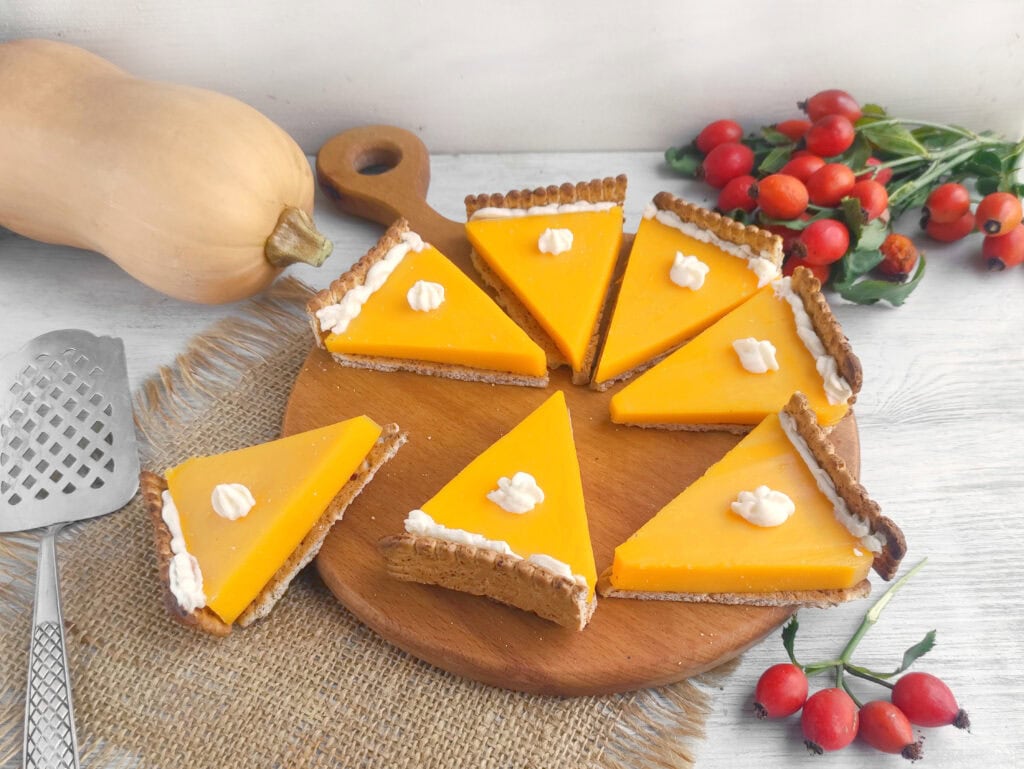 Pumpkin pie cheese and crackers on a wooden board.