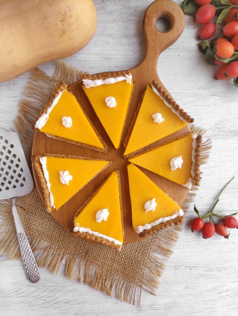 Pumpkin pie cheese and crackers on a wooden board.