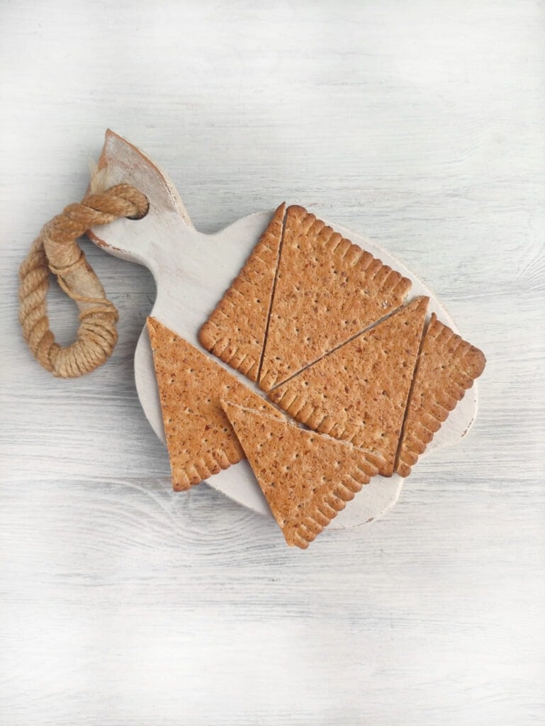 Crackers cut into triangles on a white board.