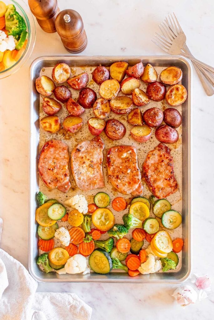 Sheet Pan Honey Garlic Pork Chops on a baking sheet in an overhead view.