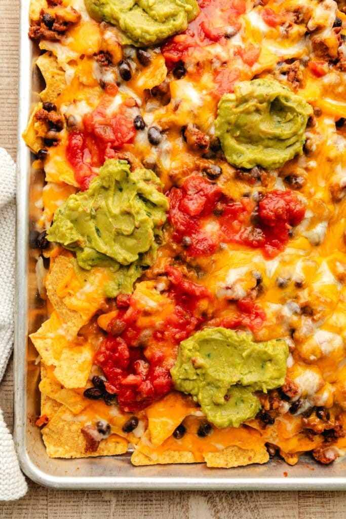 Sheet pan nachos on a baking sheet.