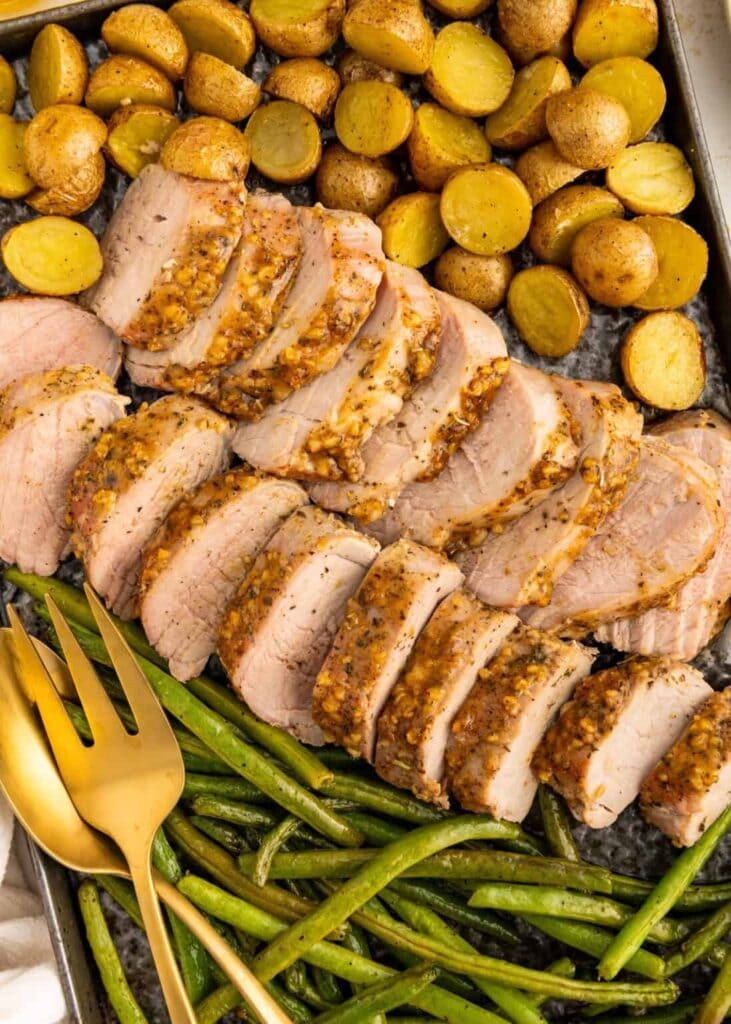 Roasted pork tenderloin on a sheet pan.