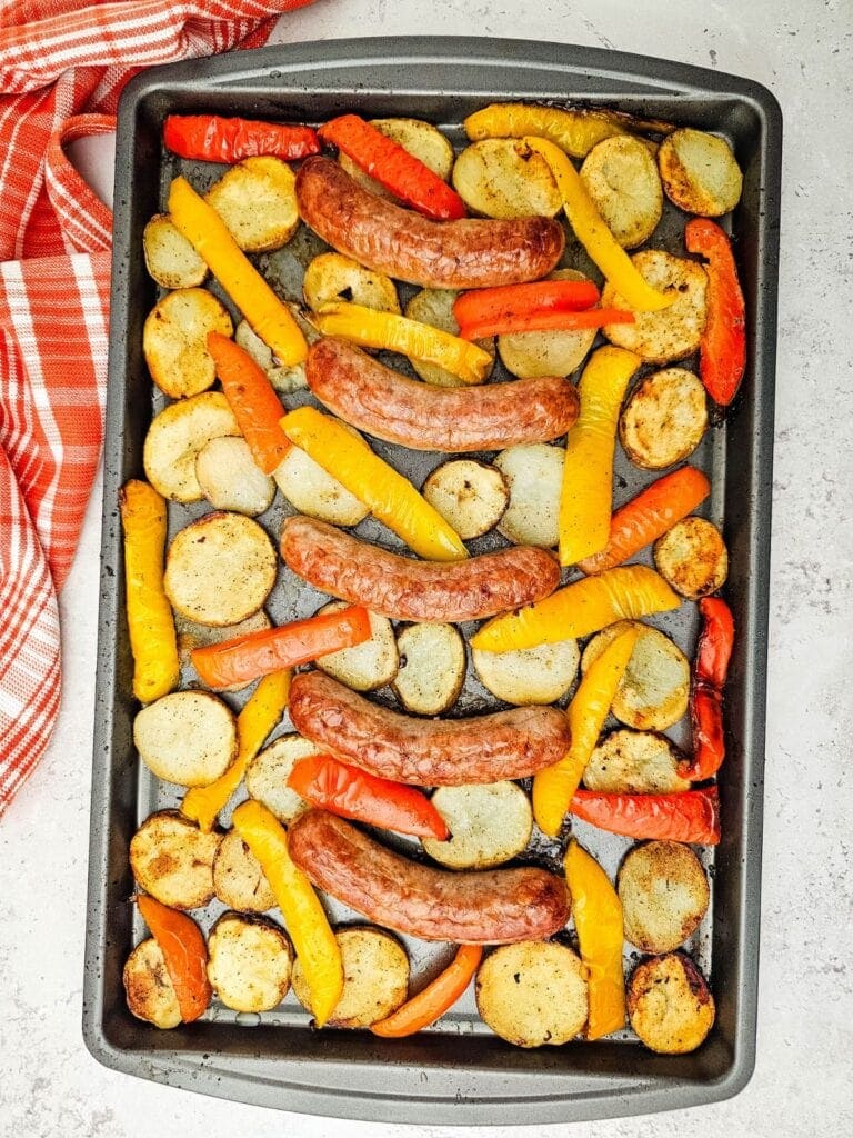 Sausage, peppers, and potatoes on a sheet pan.