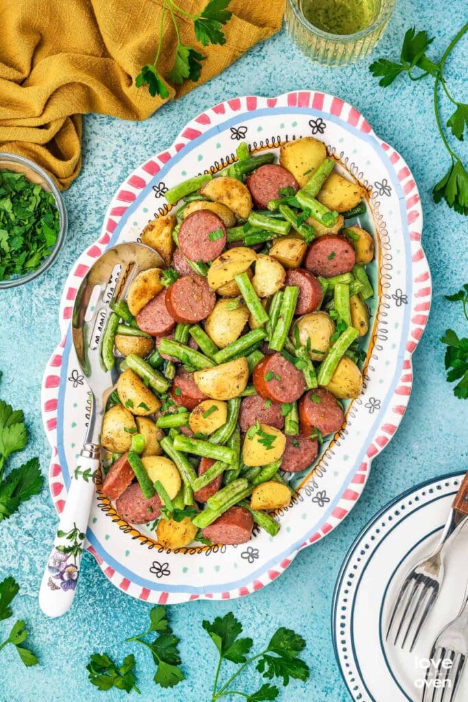 Smoked sausage and potatoes served on a plate.