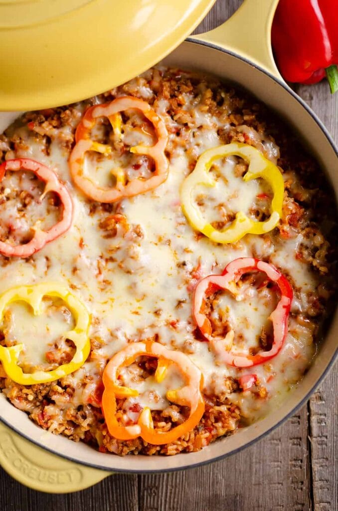 Sausage stuffed pepper in a skillet.