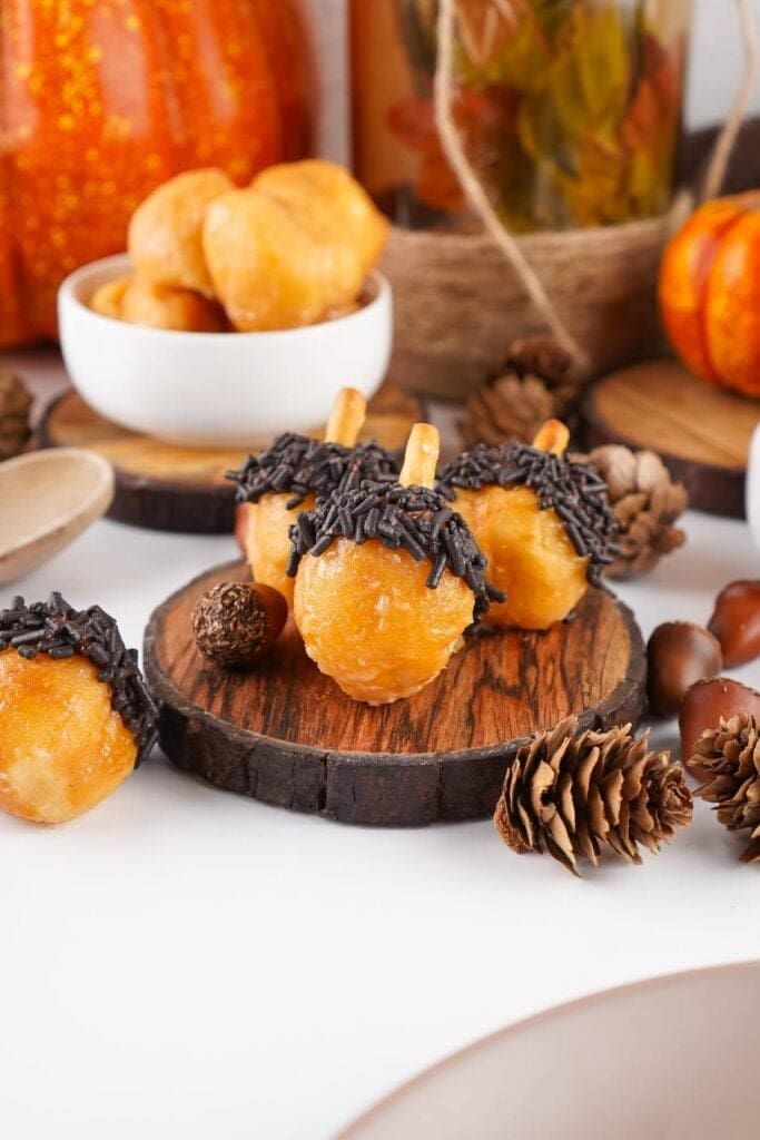 Acorn donut holes on a wooden board.