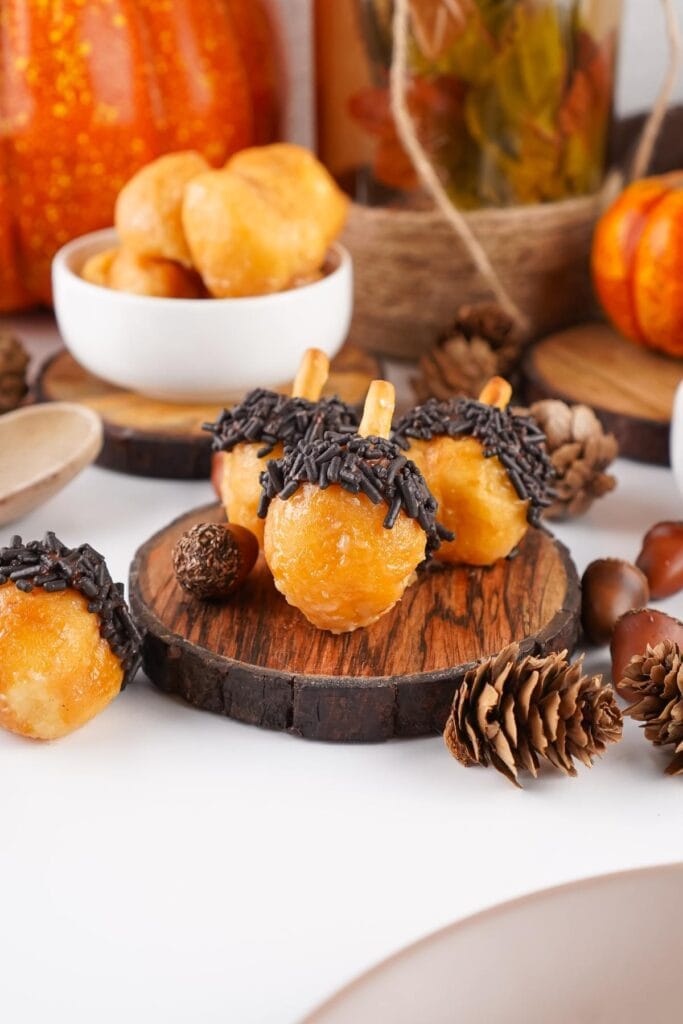 Acorn donut holes on a wooden board.