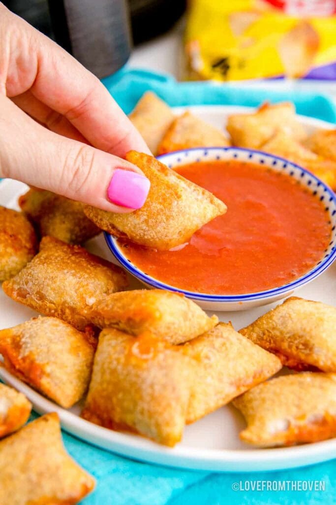 Air fryer pizza rolls served with dipping sauce.