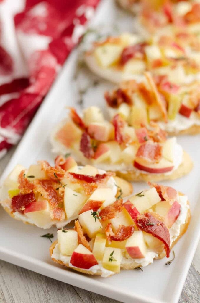 Apple bacon bleu cheese crostini on a plate.