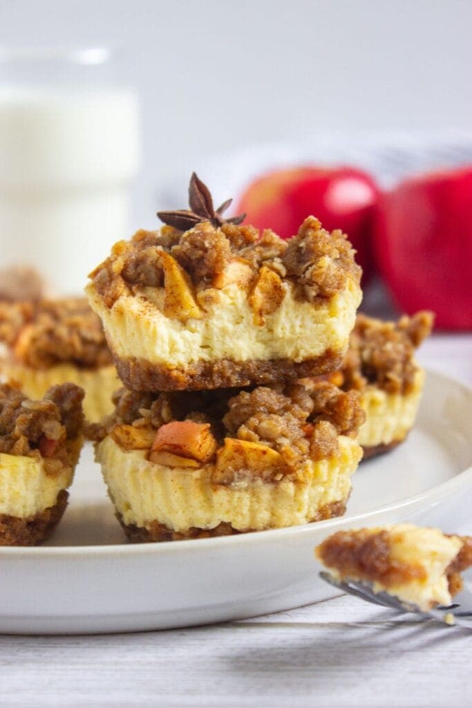 Apple crisp mini cheesecakes on a plate.