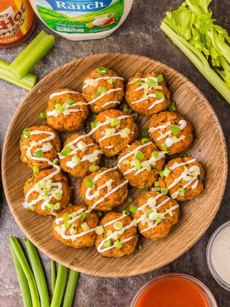 Buffalo chicken meatballs on a wooden plate.