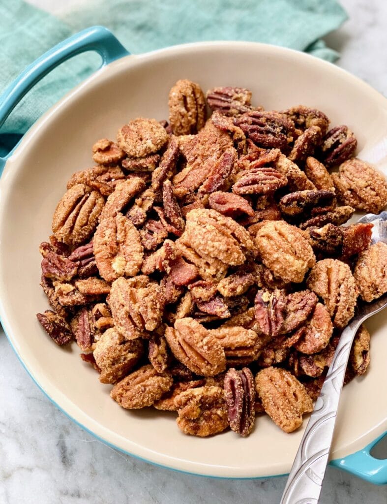 Candied bacon pecans in a handled serving bowl.