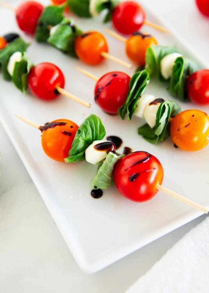 Caprese kabobs served on a plate.
