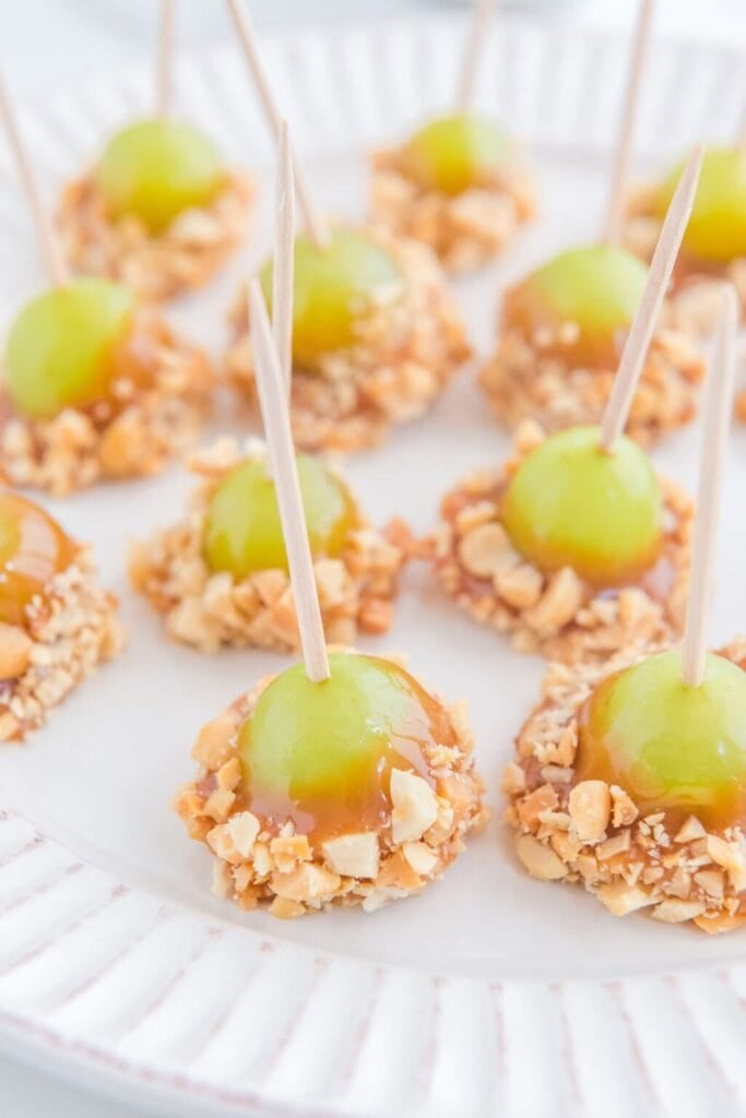 Caramel apple grapes on a plate.