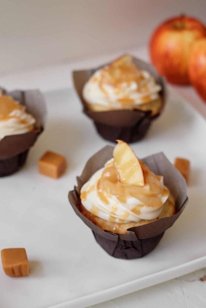 Caramel apple pie cupcakes on a plate.
