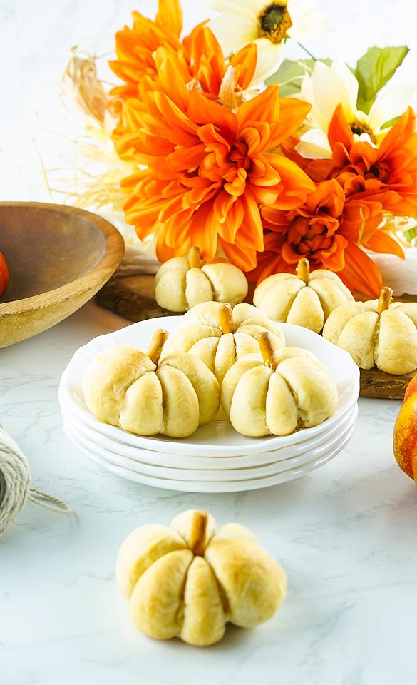 Cheese stuffed pumpkin shaped bites on a plate.