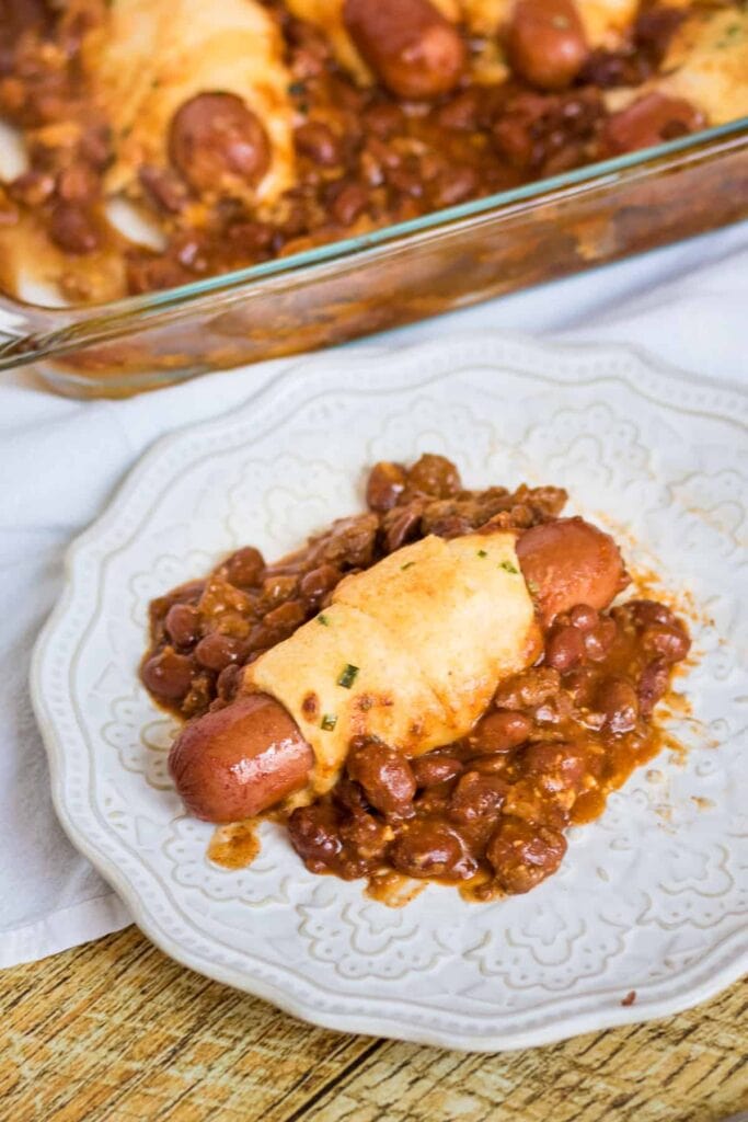 Chili cheese dog casserole served on a plate.