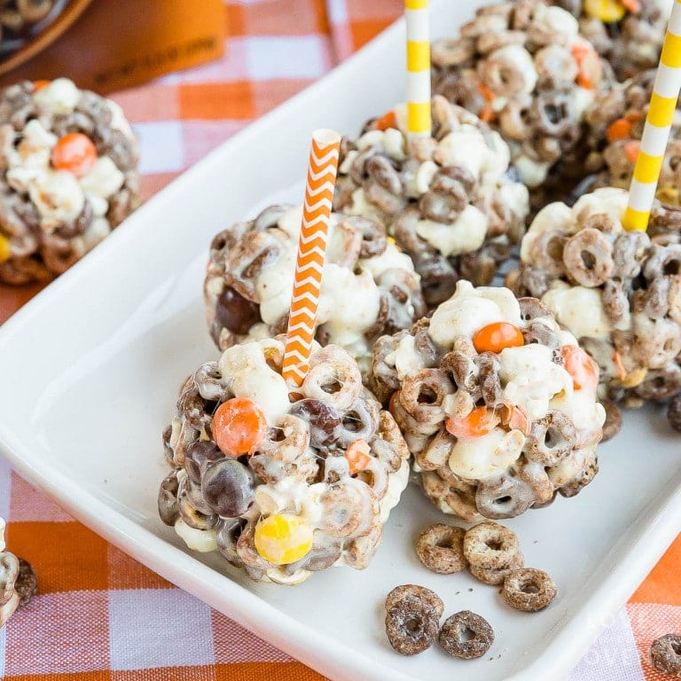Chocolate peanut butter Cheerios popcorn balls on a plate.