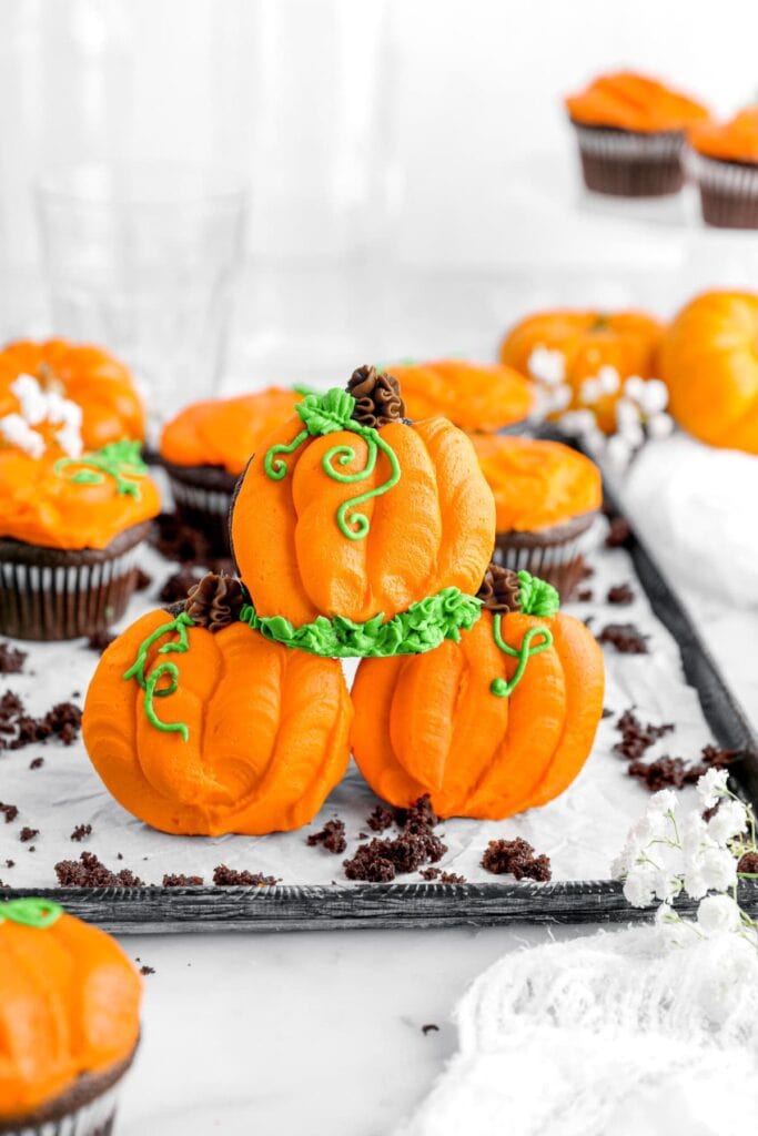 Chocolate pumpkin cupcakes on a plate.