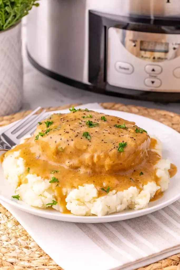Creamy Crockpot Ranch Pork Chops served on a plate.