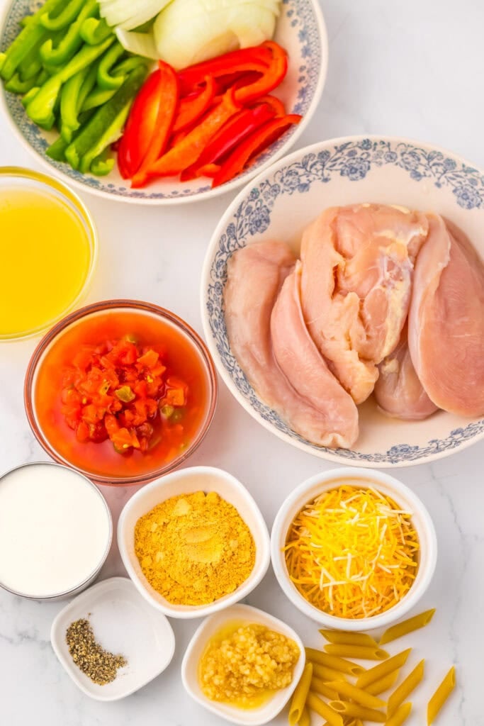 Ingredients for crockpot chicken fajita pasta on a table.