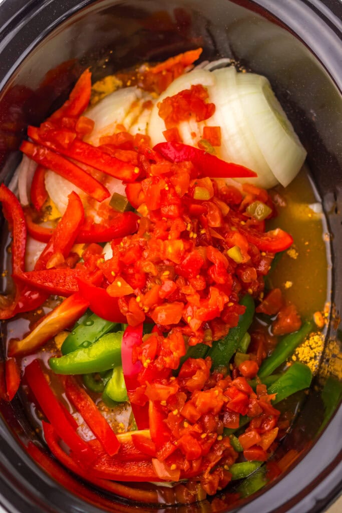 Chicken topped with peppers, onion, and tomatoes.