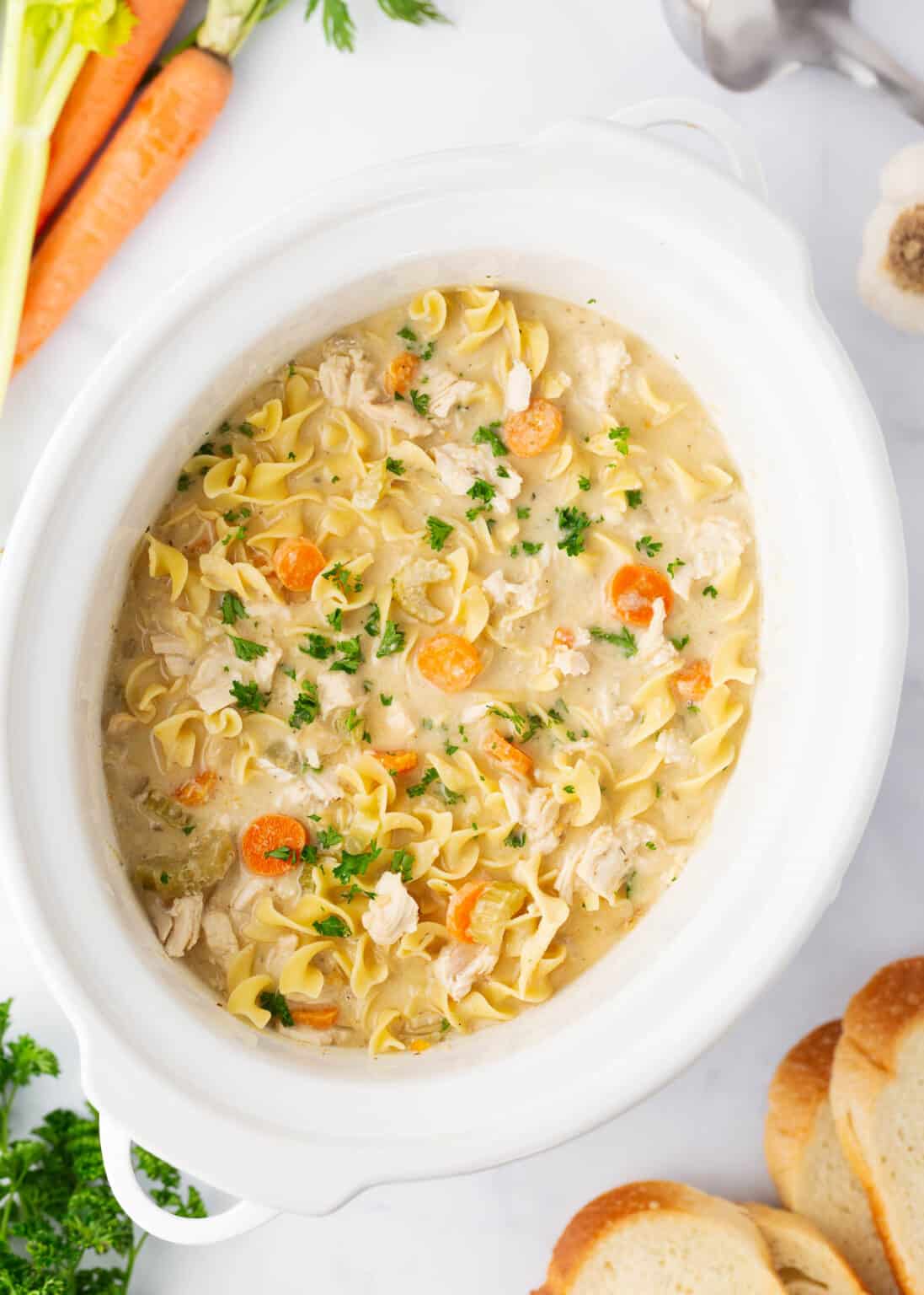 Chicken noodle soup in a slow cooker.