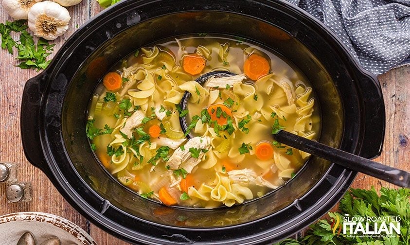 Chicken noodle soup in a slow cooker.