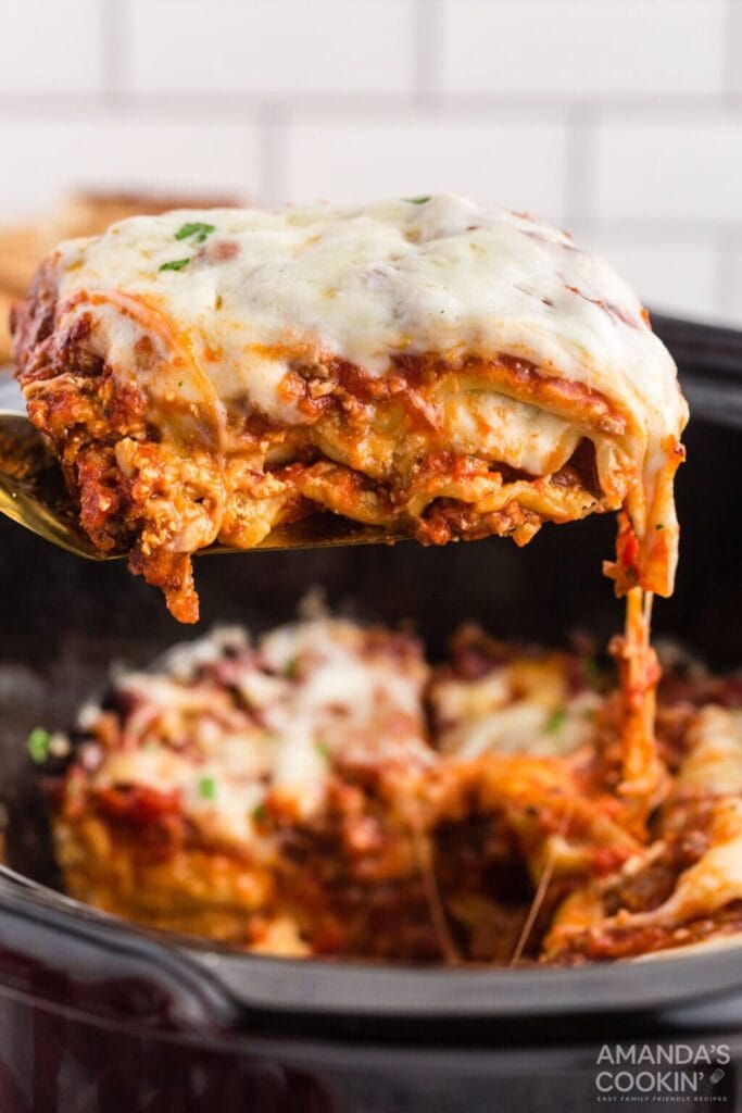 Close up of crockpot lasagna on a spoon.