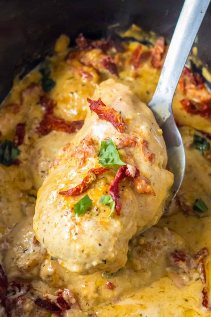 Close up of crockpot Marry Me chicken on a spoon.