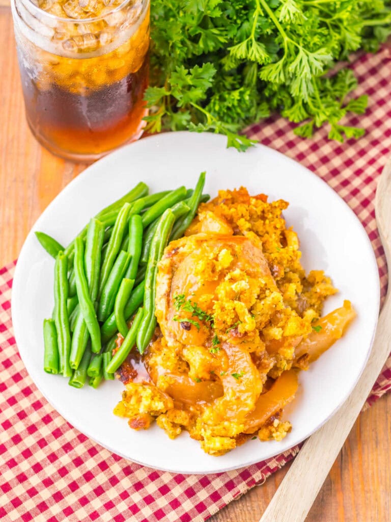 Crockpot pork chops with apples and stuffing served on a plate.