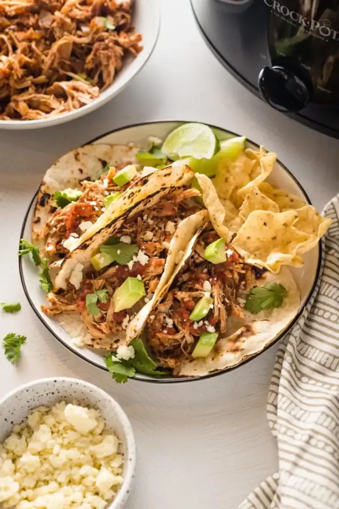 Crockpot shredded chicken tacos on a plate.